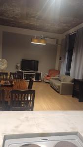 a living room with a couch and a tv at Casa Rafael in La Plata