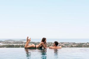 a man and a woman in the water at Savaya Samui Villa in Ban Ko Khwan