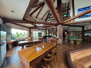 a large room with wooden tables and ping pong tables at スピークイージー in Higashiizu