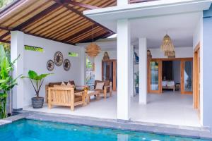 a villa with a swimming pool and a house at Villa Jati Private Pool - Amed in Amed
