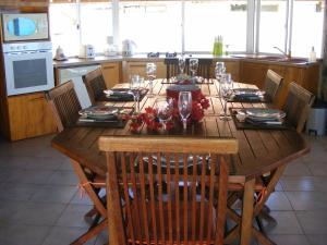 a wooden table in a kitchen with a dining room at FARE MOOREA in Moorea