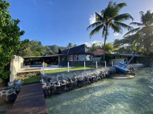 a house by the water with a bunch of animals at FARE MOOREA in Moorea