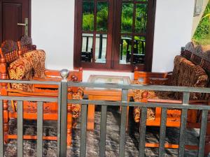 a glass table and two chairs in a room at Lumora Resort in Horuwila
