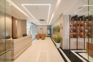 a lobby of a hotel with a reception desk and a hallway at San Hanoi Hotel & Gaming in Hanoi