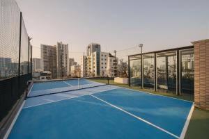 a tennis court on the roof of a building at San Hanoi Hotel & Gaming in Hanoi