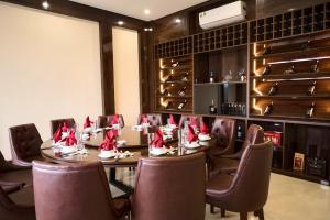a dining room with a table and chairs with shoes on it at HAO LAN LUXURY Hotel in Bắc Quang