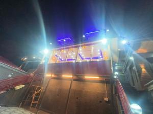 a bus with lights on a street at night at Shiva cottage in Kullu Manali