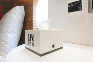 a white box sitting on top of a bed at In Inn in Hong Kong