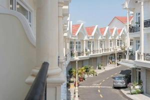 a view of a street with houses and a car at House Nguyễn in Da Lat