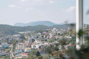 a city with houses and mountains in the background at House Nguyễn in Da Lat