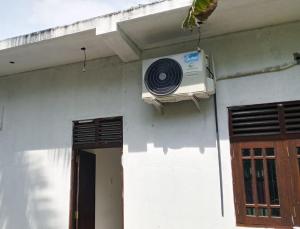 a air conditioner on the side of a house at Villa Rashel in Nikawatawana