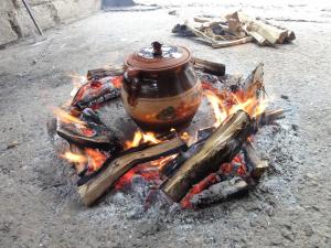 a pot is sitting on top of a fire at StaroplaninSki Apartments in Crni Vrh