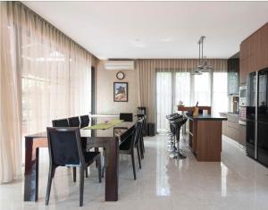 a kitchen and dining room with a table and chairs at Green Minimalist in Jakarta