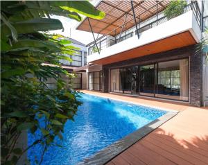 a swimming pool in the middle of a house at Green Minimalist in Jakarta