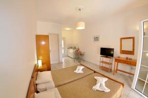 a living room with a couch and a table at Egli Apartments in Kontokali