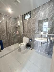 a bathroom with a toilet and a sink at La Maison 230 in Ban Khlong Samrong +29 photos