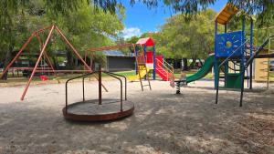 a playground with many different types of playground equipment at Four Seasons Holiday Park in Marybrook