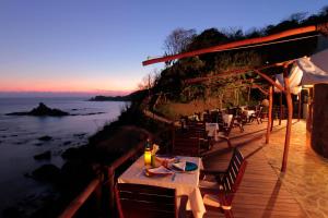 a restaurant with a table and a view of the ocean at Zoa Hotel in Mazunte