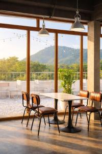 a dining room with a table and chairs with a view at HAO LAN LUXURY Hotel in Bắc Quang