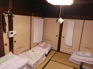 a room with three beds and a light at x r2602 Ono-Villa in Onomichi