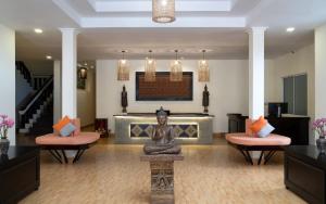a lobby with a statue in the middle of a room at Indochine Sanctuary Boutique in Siem Reap