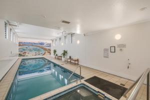 a swimming pool in a building with a painting on the wall at Quest Newcastle in Newcastle