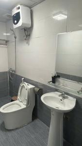 a bathroom with a toilet and a sink at Catba Chilling House Pool & Bar in Cat Ba +13 photos