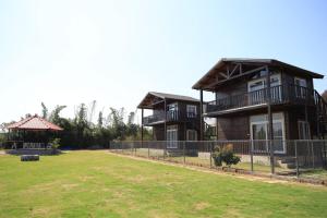 a large house with a yard in front of it at Therpup Resort in Bangalore
