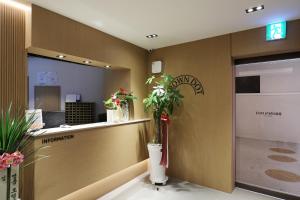 an office lobby with a reception counter and plants at 부천 브라운도트 호텔 부천역점 in Sosa