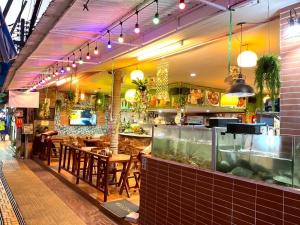 a restaurant with tables and chairs and a bar at Golden Bee PhiPhi in Phi Phi Islands