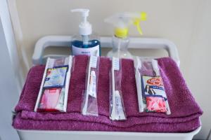a purple towel with toothbrushes and other bathroom items on it at SYARIAH - 3BR Homeyy by Sakura in Krawang +20 photos