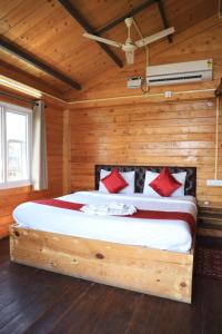 a bedroom with a bed in a wooden room at Therpup Resort in Bangalore