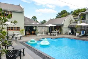 a swimming pool with inflatables in a yard at Apartment 7 On Oakleigh in Pietermaritzburg