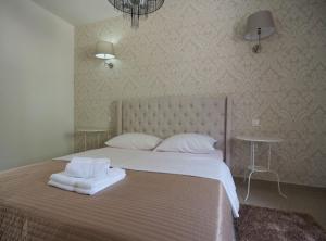 a bedroom with a large bed with two pillows on it at Pula Garden Apartments with Shared Pool in Pula