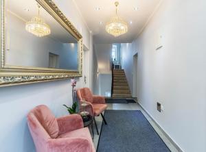a hallway with two chairs and a mirror at Pula Garden Apartments with Shared Pool in Pula
