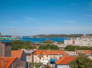 a view of the city and the water at Pula Garden Apartments with Shared Pool in Pula +55 photos