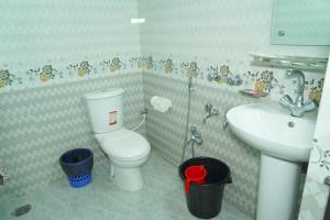a bathroom with a toilet and a sink at Hotel Grand Shah Kamal in Sylhet +26 photos