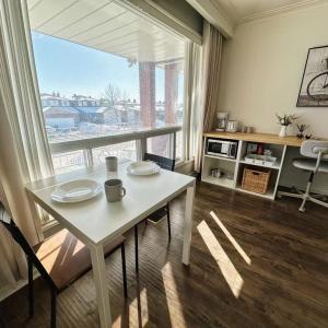 a living room with a table and a large window at Cozy Studio with 2 Beds & Private Bathroom in Toronto