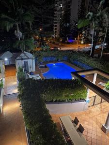 an overhead view of a swimming pool at night at San Mateo On Broadbeach in Gold Coast