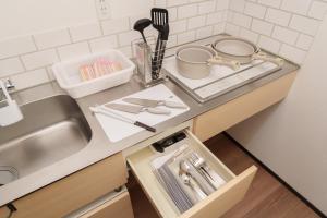 a kitchen counter top with a sink and a sink at LilyHouse in Beppu +22 photos