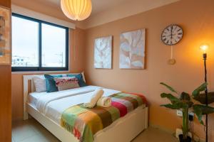 a bedroom with a bed with a clock on the wall at Johny's Spot in Larnaca in Larnaca
