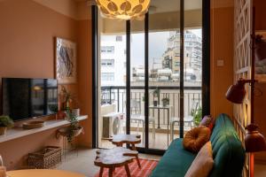 a living room with a couch and a large window at Johny's Spot in Larnaca in Larnaca