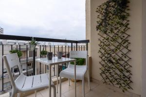 a balcony with a table and chairs on a balcony at Johny's Spot in Larnaca in Larnaca