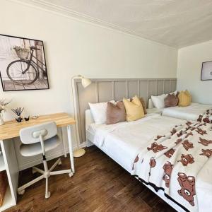 a bedroom with two beds and a desk and a desk at Cozy Studio with 2 Beds & Private Bathroom in Toronto