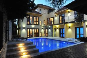 a house with a swimming pool in front of a house at ONE LUXE JAMAICA VILLA with private pool, modern interior and secluded in Ocho Rios