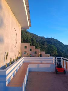a house with a red car parked on a balcony at Villa Kanaya in Sukapura