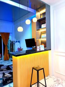 a yellow counter with a stool in a room at Villa Kanaya in Sukapura