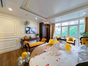 a room with a table with balloons on it at Aloha Hotel in Hanoi