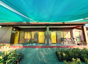a house with a blue tarp over the front porch at Traveller Hive Kasar Devi in Almora