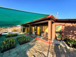 a house with a patio with plants in front of it at Traveller Hive Kasar Devi in Almora